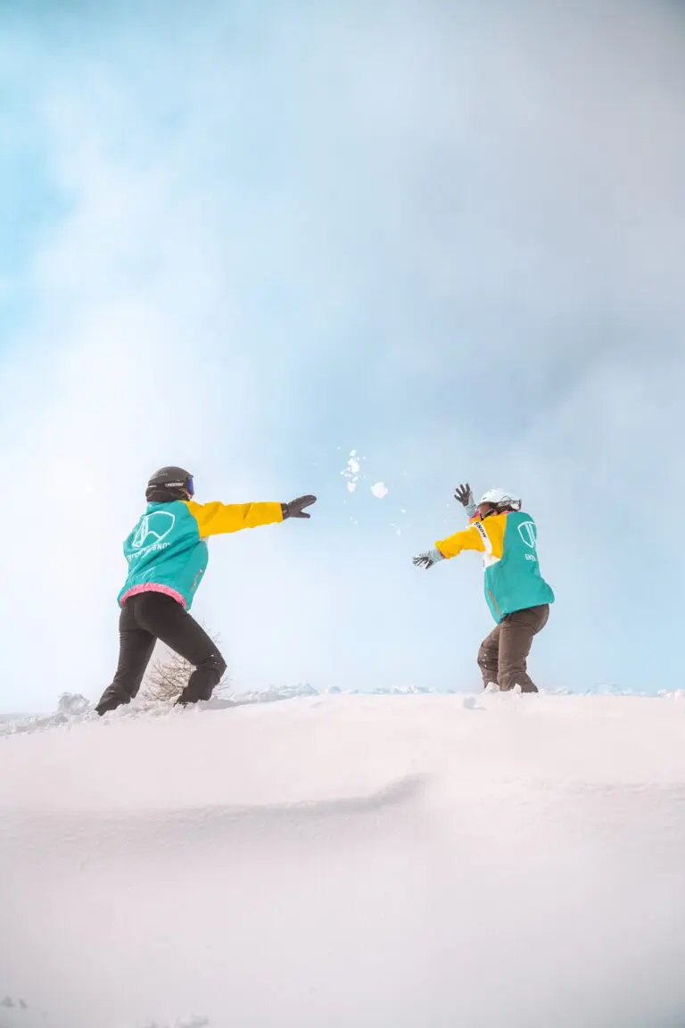 two people having a snowball fight in a snowy landscape