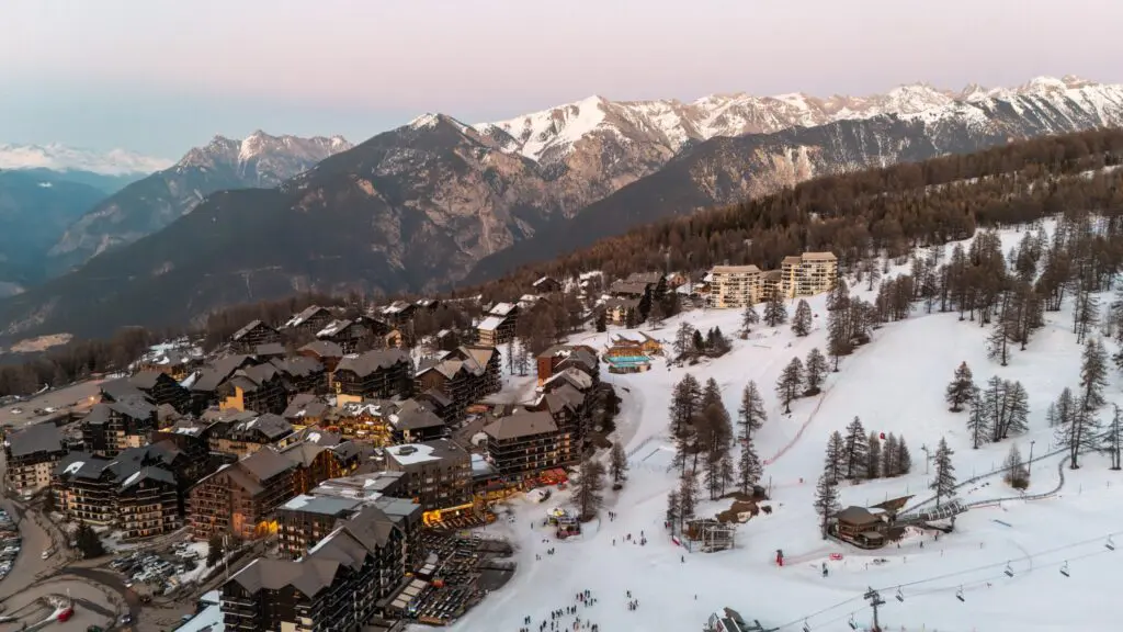 aerial view of Risoul ski resort and snowy mountains at dusk