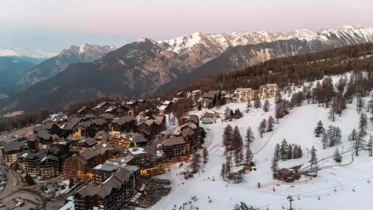 aerial view of Risoul ski resort and snowy mountains at dusk