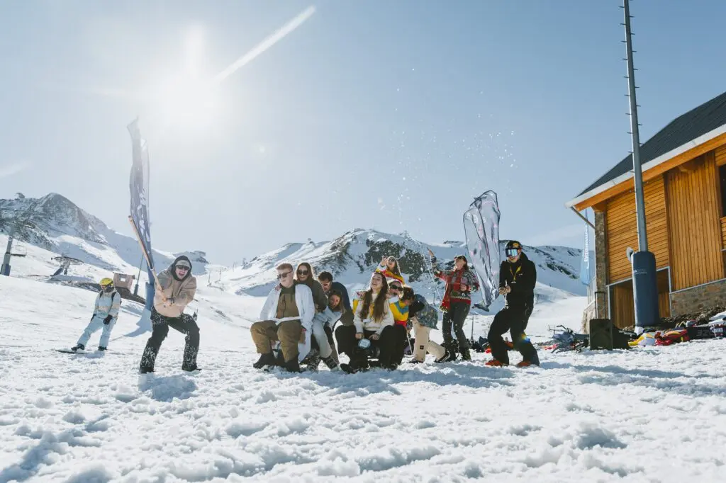 group of friends celebrating in the snow at a ski resort
